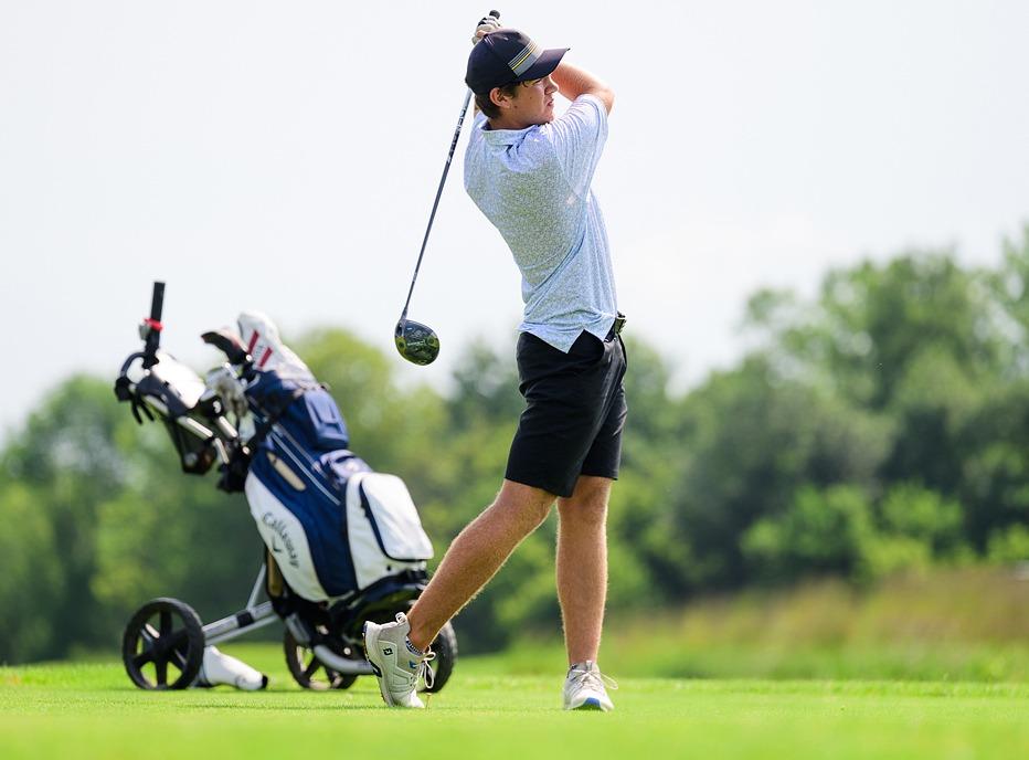 A person swinging a golf club on a course at the Firerock Golf Club located in Komoka, Ontario
