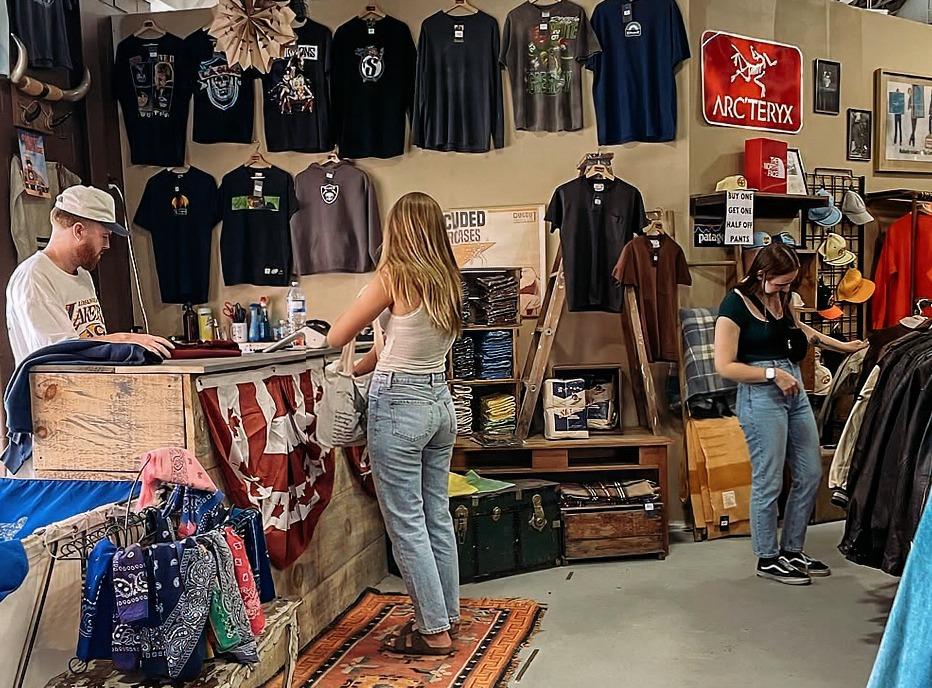Two females shopping for vintage clothing in DugOut Vintage, located in London, Ontario
