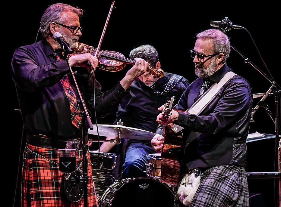Musicians from the band The Celtic Kitchen Party playing live on stage