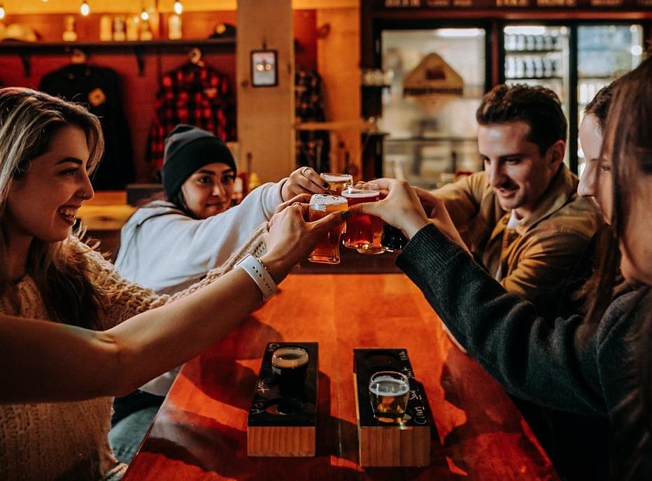 A group of people drinking beer at the PowerHouse Brewery located in London, Ontario