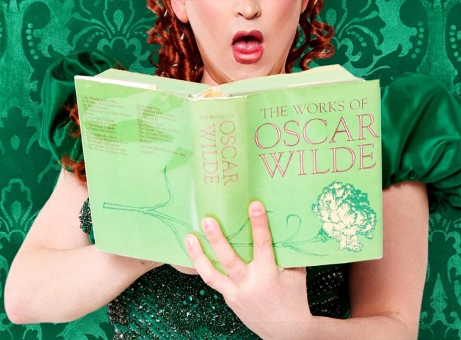 An actreess reading a book from the production of Being Earnest playing at the Grand Theatre located in London, Ontario
