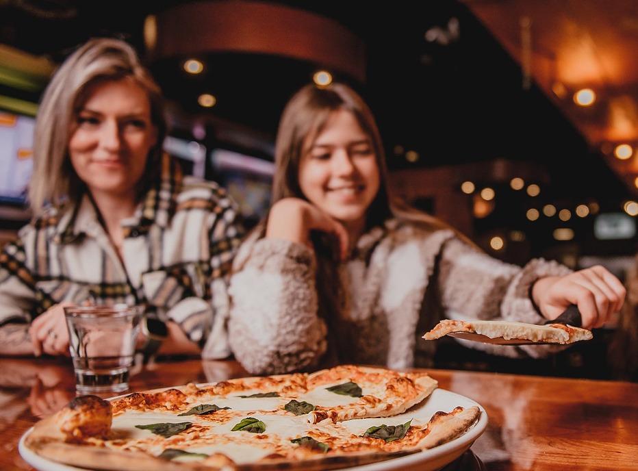 A mother and daughter enjoying a pizza from Toboggan Brewing Company