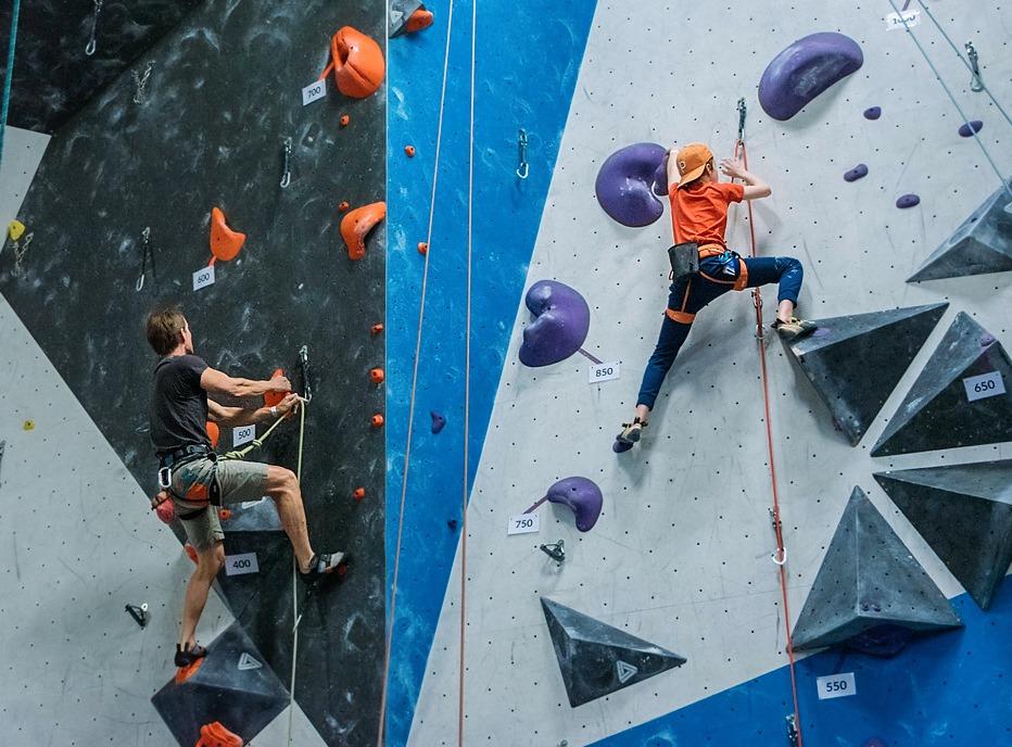 Two people climbing a wall indoors at Junction Climbing Centre locate din London, Ontario