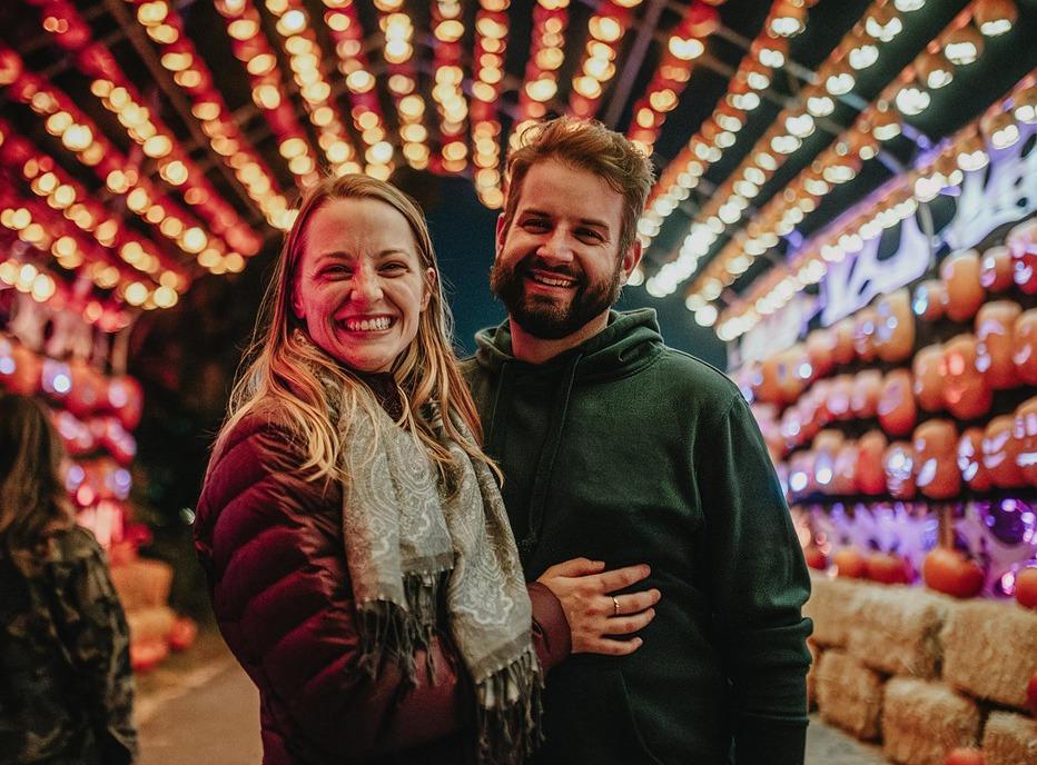 A couple standing in front of display at Pumpkins After Dark, located in London, Ontario