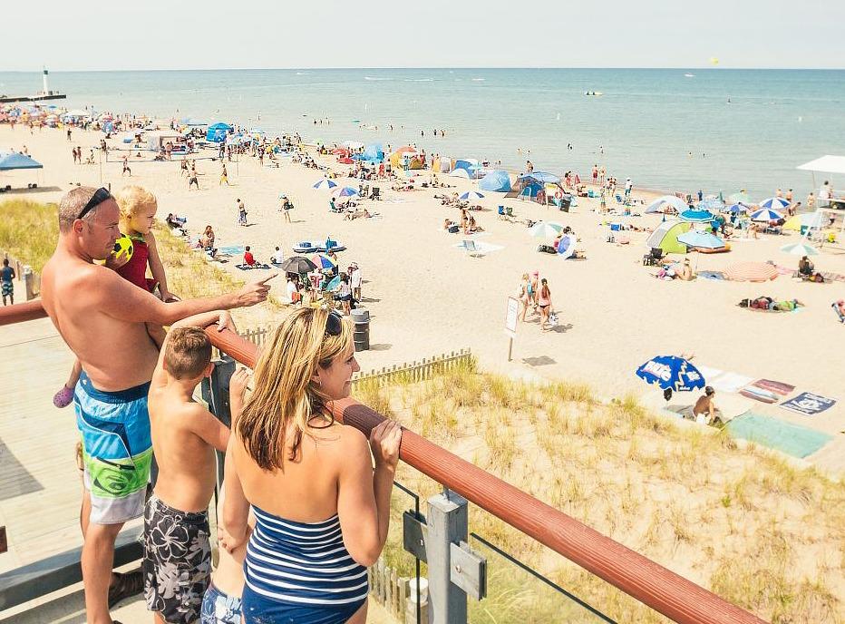 A family enjoying the view overlooking Grand Bend's beachfront on a hot summer day