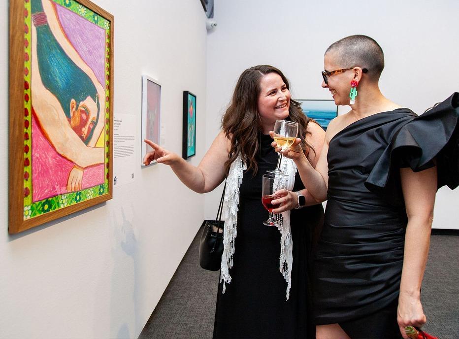 Two females looking at a piece of art on display at Museum London, located in London, Ontario