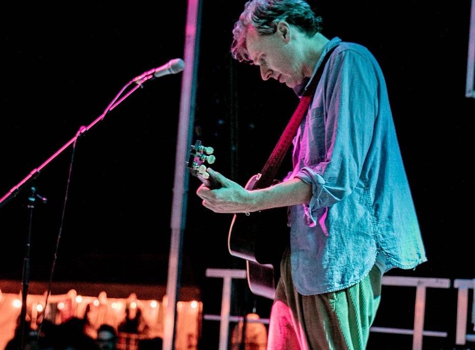 Musician Joel Plaskett playing live to an audience outdoors