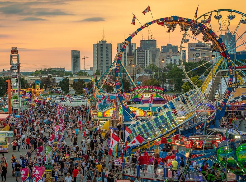 A  aerial view of the Western Fairgrounds with various rides and games brightly lit located in London, Ontario