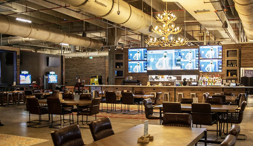 Interior view of The Clubhouse's bar and dining area at 100 Kellogg Lane