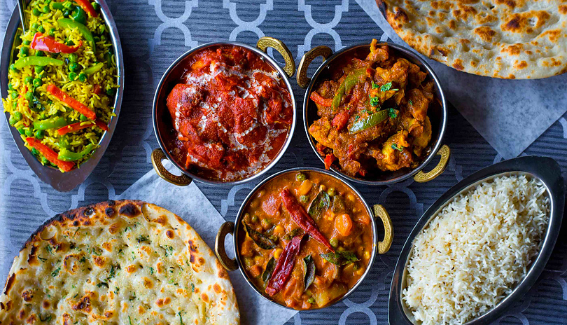 Various Indian dishes on a table from Aroma of India located in London, Ontario