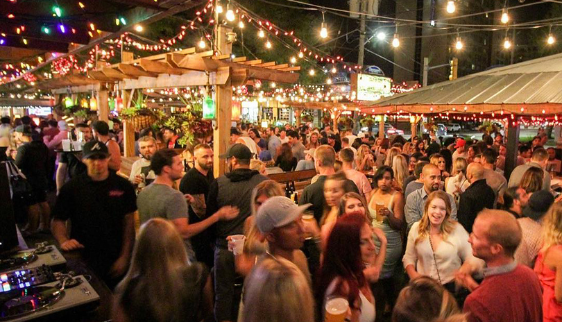 A large crowd gathered outdoors at night at the patio of Barney’s and The Ceeps located in London, Ontario, Canada