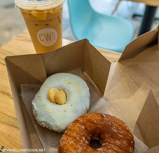 donuts in a box next to drink