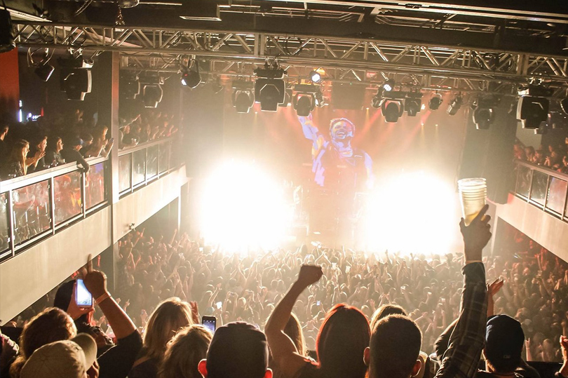 A packed crowd cheering as they watch a concert at London Music Hall located in London, Ontario