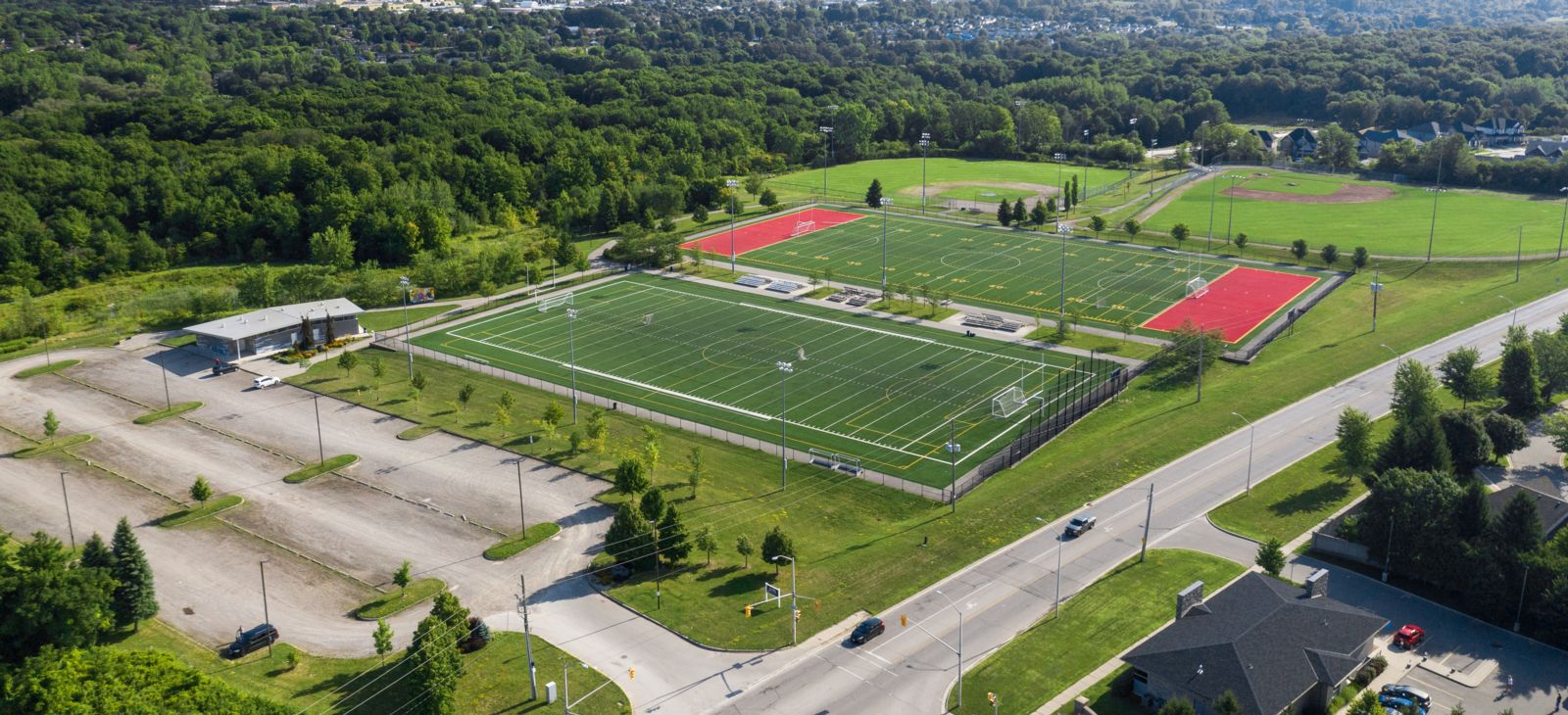 Aerial view of City Wide Sports Park - 2 soccer or football fields surrounded by trees and greenery
