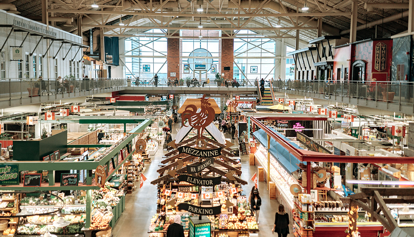 A second floor view of Covent Garden Markets main floor with various vendors and people walking and shopping, located in London, Ontario, Canada