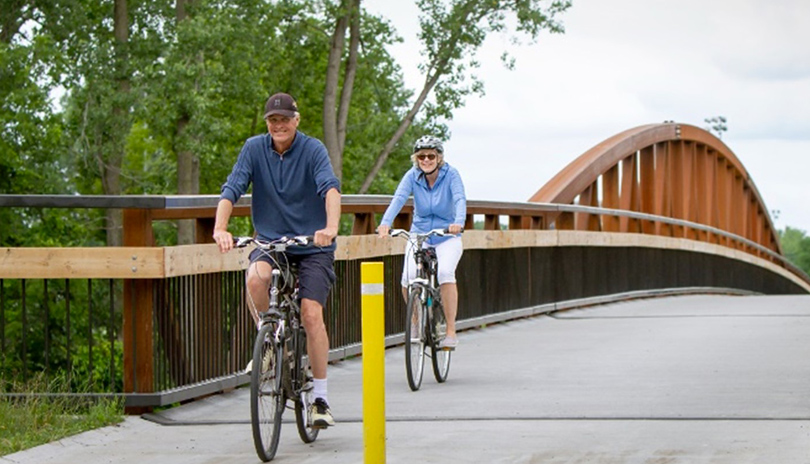 Two people biking through Blackfriars Bridge located in London, Ontario