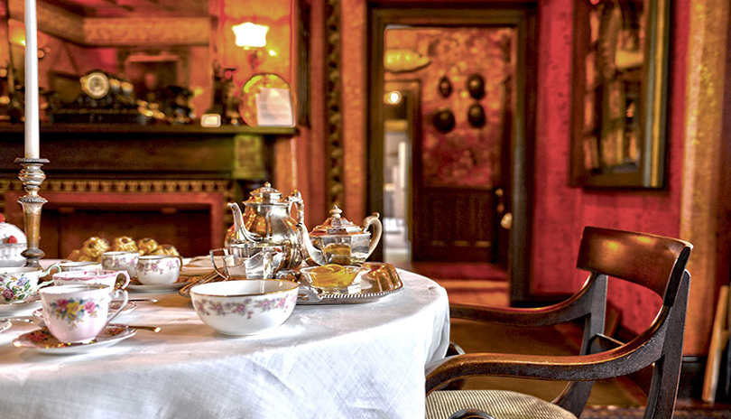 A close up view of a historic decorated table with tea cups and dishes in the dining room of the Eldon House locate din London, Ontario, Canada