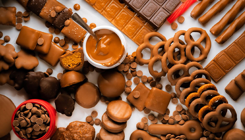 A table top view of various types of chocolates, ranging from chocolate covered pretzels to chocolate chips, from Forrats Chocolate located in London, Ontario, Canada