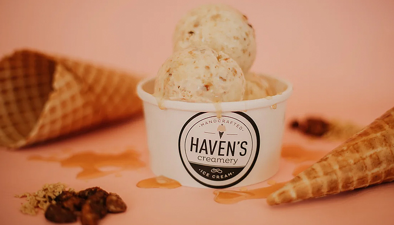 Ice cream served in a bowl with cones resting on a table beside it from Havens Creamery located in London, Ontario