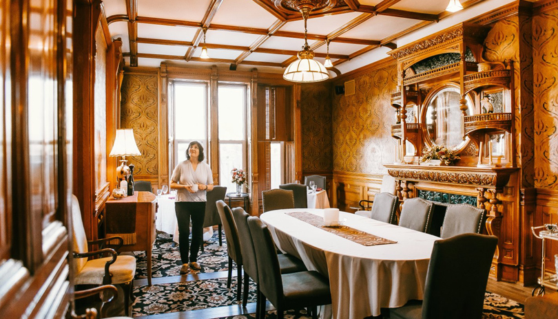 A woman admiring the indoor dining room of the Idlewyld Inn & Spa located in London, Ontario