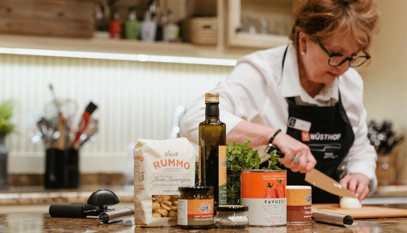 A women preparing food on a counter in Jill's Table.