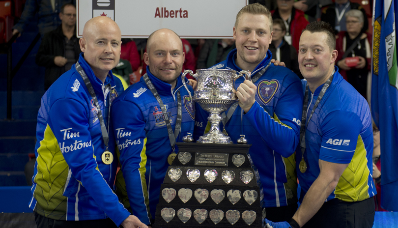Team Alberta skip Kevin Koe, third B.J. Neufeld, second Colton Flasch and lead Ben Hebert hold the Brier Cup