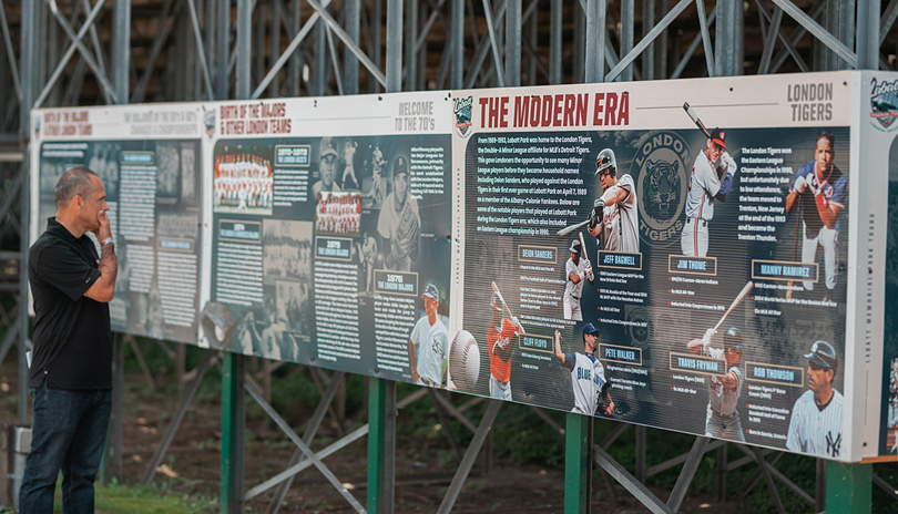 A man looking at a historic mural on display at Labatt Park, The World's Oldest Operating Baseball Grounds, located in London, Ontario, Canada