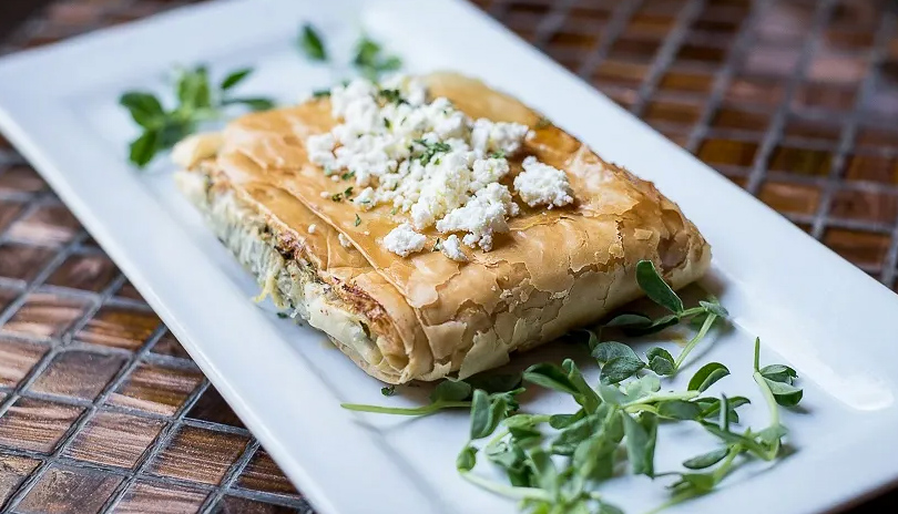 Greek food from Mythic Grill served on a plate and displayed on a table