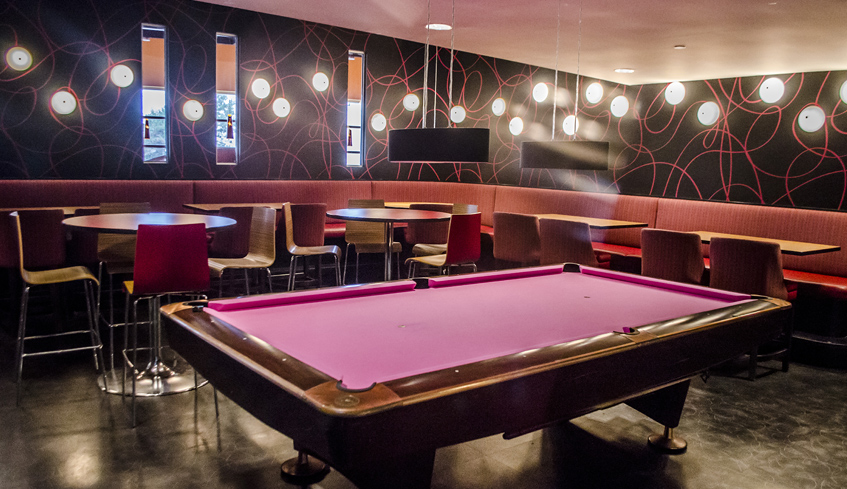 Tables and chairs surrounding a poor table in Palasad SocialBowl, located in London, Ontario. 