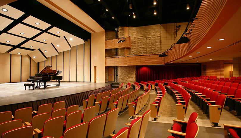 An empty theatre with a grand piano on the stage at Paul Davenport Theatre located in London, Ontario