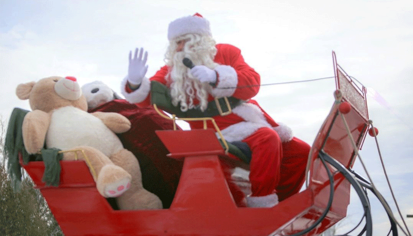 Santa Claus driving his sleigh.