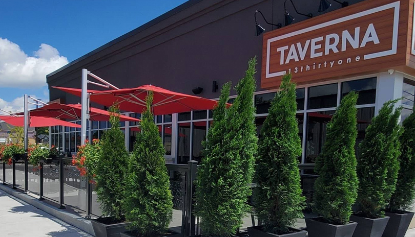 Outdoor view of Taverna 13Thirtyone's patio on a bright summer day, located in London, Ontario, Canada