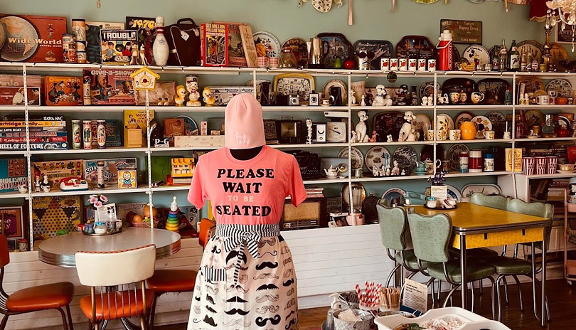 interior view of The Bag Lady's dining area with various vintage games and objects displayed on a wall, located in London, Ontario