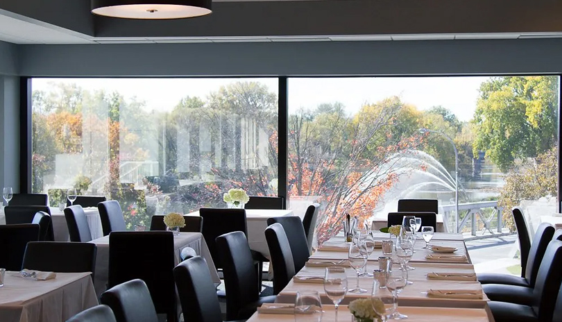 The indoor dining area of The River Room Cafe & Private Dining overlooking the Thames River located in London, Ontario