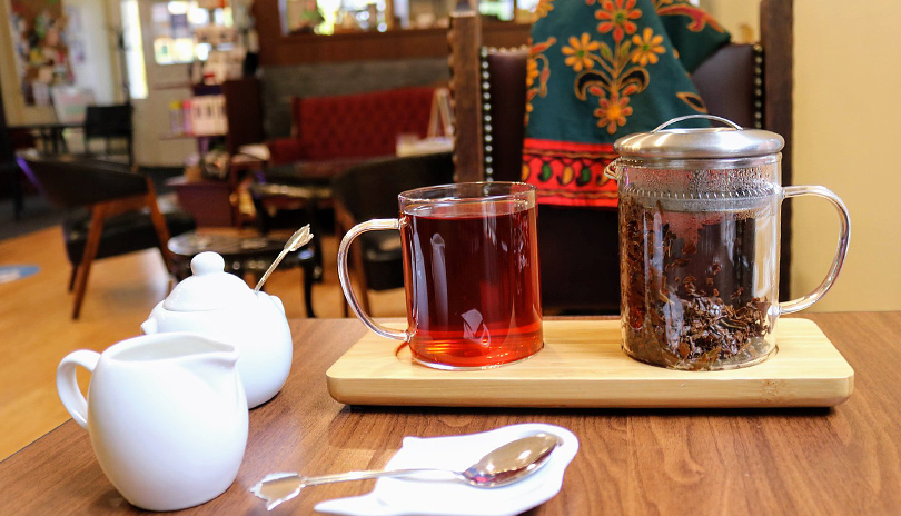 A table with a cup of tea and sugar resting on a table inside the main showroom of The Tea Lounge located in London, Ontario