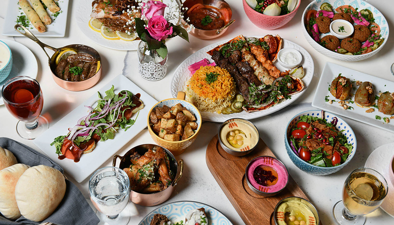 Various Lebanese dishes displayed on a large table by Yasmine’s Authentic Lebanese Cuisine located in London, Ontario