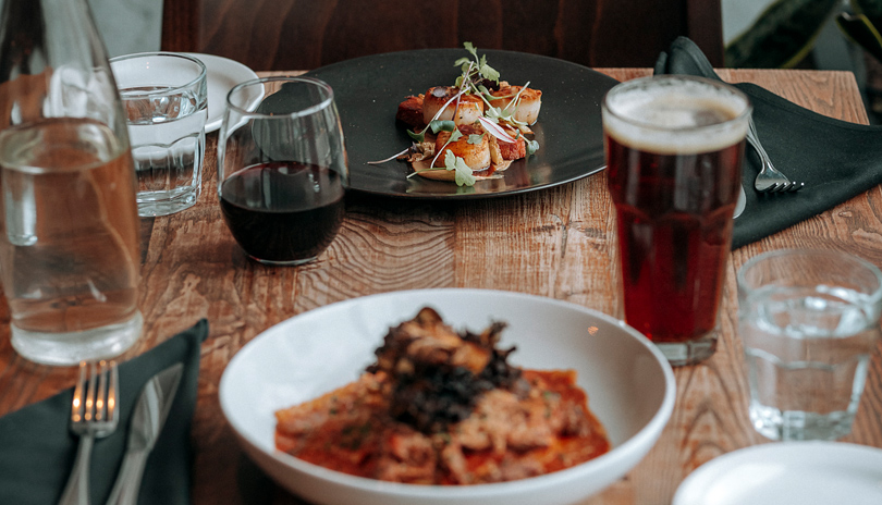 Table top view  of two dishes and drinks at Abruzzi restuarant in London, Ontario