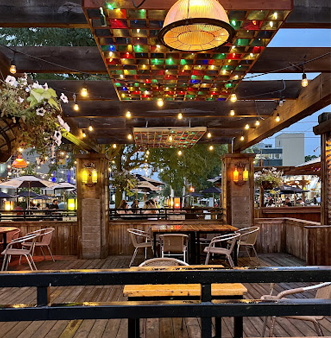 empty patio displaying colourful lights, tables and chairs