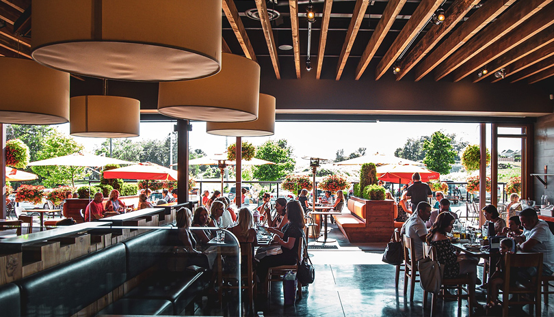 The interior dining room and open outdoor patio of Dolcetto restaurant located in London, Ontario