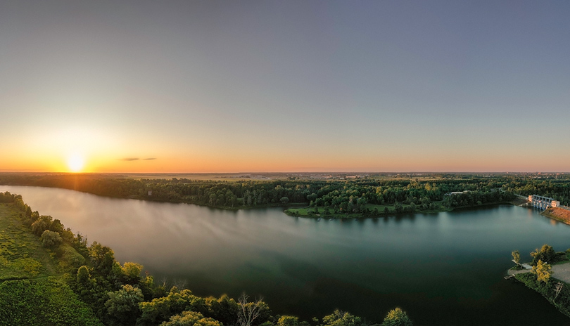 An aerial view of a body of water and forest surrounding it at the Fanshawe Conservation Area located in London, Ontario