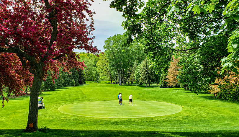 A group of people golfing on a bright sunny day at East Park Golf Club located in London, Ontario