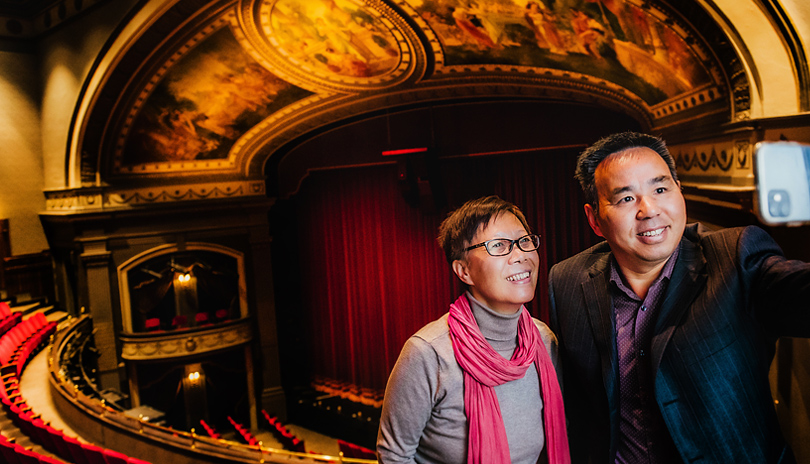 A couple taking a selfie on the balcony of Grand Theatre in London, Ontario