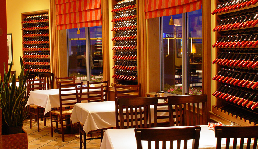 Pastos Grill dining area table and wine bottles located in London, Ontario