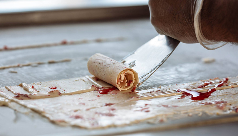 Ice cream being rolled on marble slab