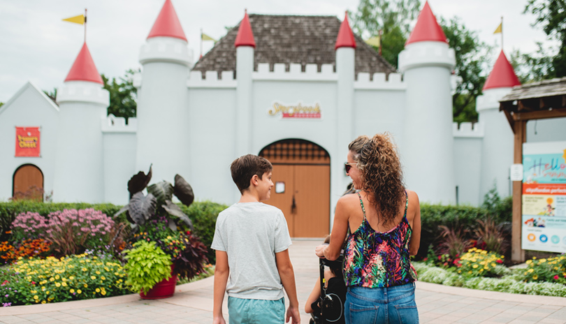 A family at the main castle entrance of Storybook Gardens located in London, Ontario