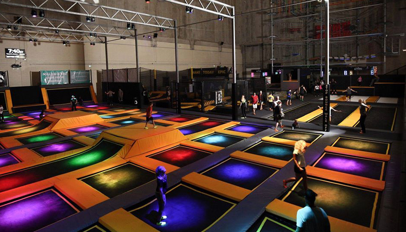 Various people jumping on colourful pads at The Factory located in London, Ontario
