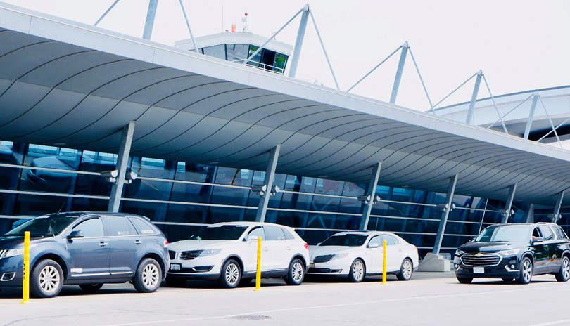 Voyago vehicles line up outside of the London International Airport, located in London, Ontario, Canada