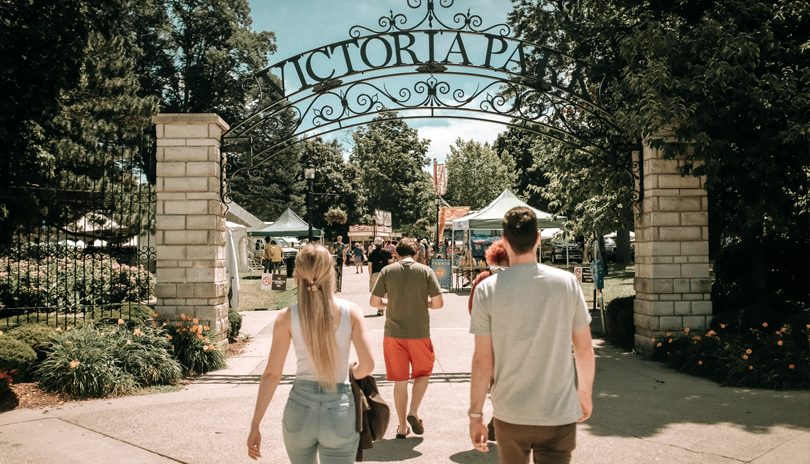 A group of people about to walk into the main entrance of Victoria Park located in London, Ontario