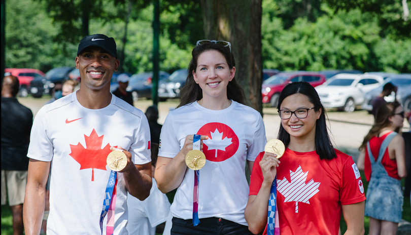 Damian Warner, Susanne Grainger and Maggie MacNeil holding their Olympic Gold Medals