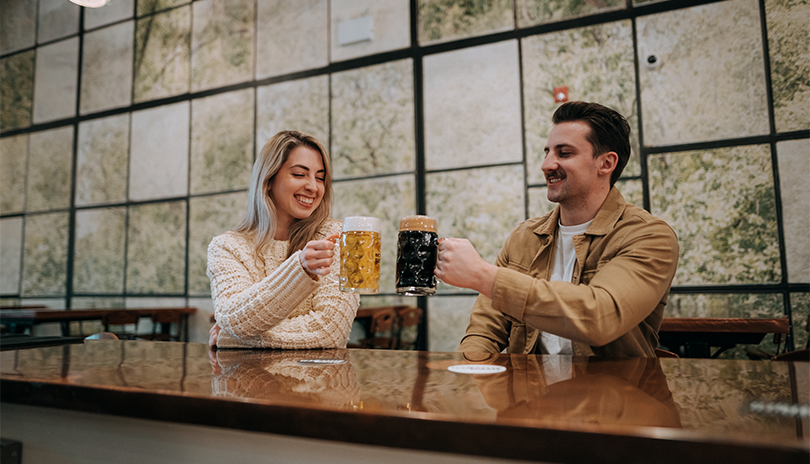 Two people enjoying a freshly poured beer at the Beer Kitchen at 100 Kellogg Lane